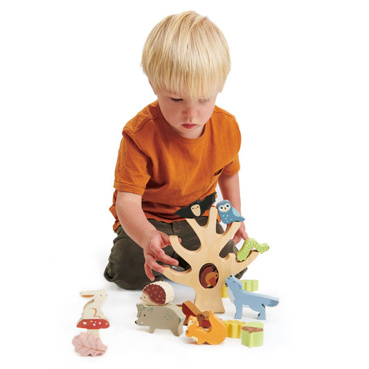 Stacking forest pieces laid flat — owl, fox, hedgehog, rabbit, wolf, woodpecker, caterpillar, and leaves