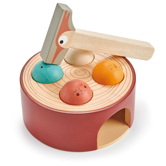 Top view of the tap game showing the three painted critters peeking up from the tree-stump