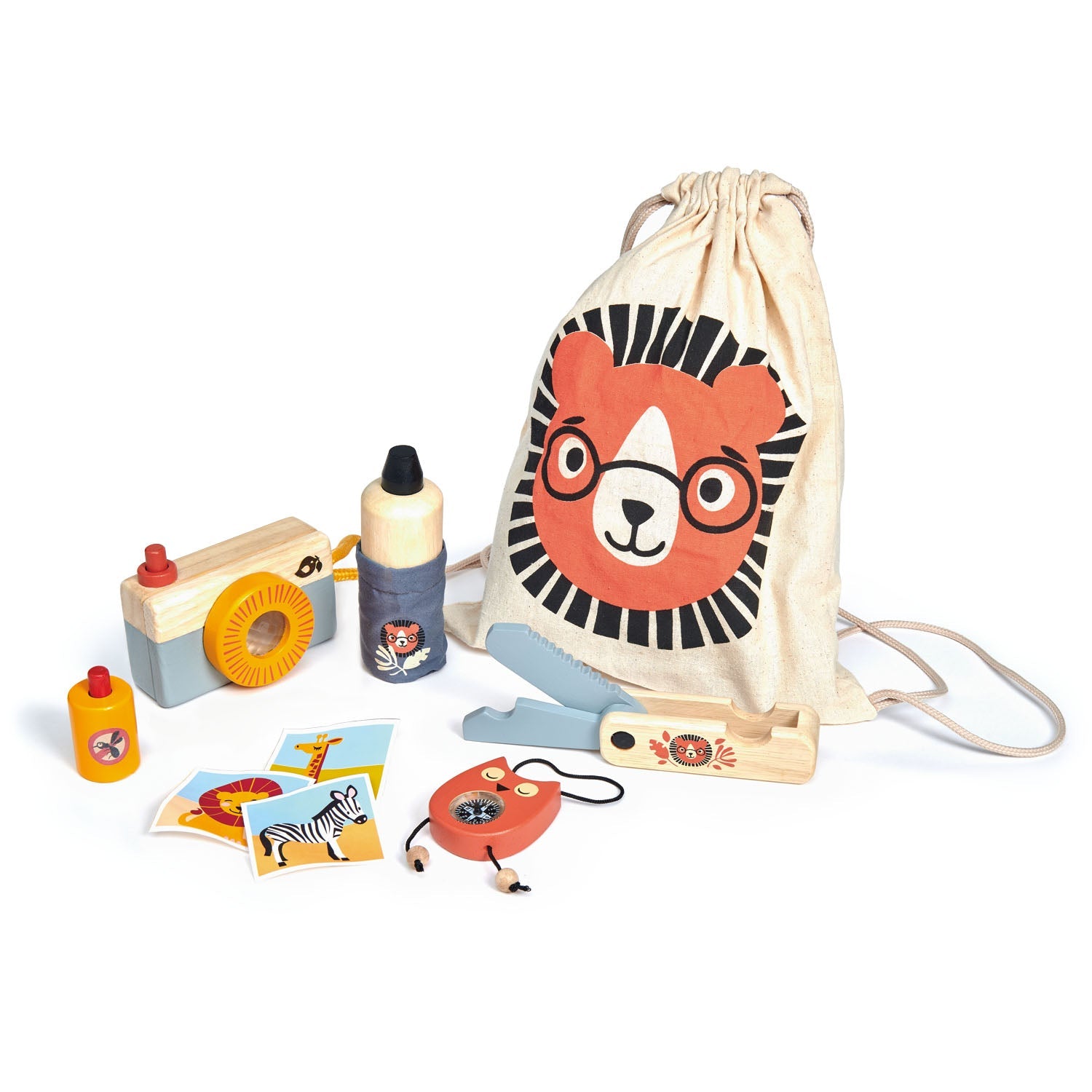 Cotton drawstring bag with hand-painted lion graphic next to wooden compass, camera, penknife, water bottle, and bug spray