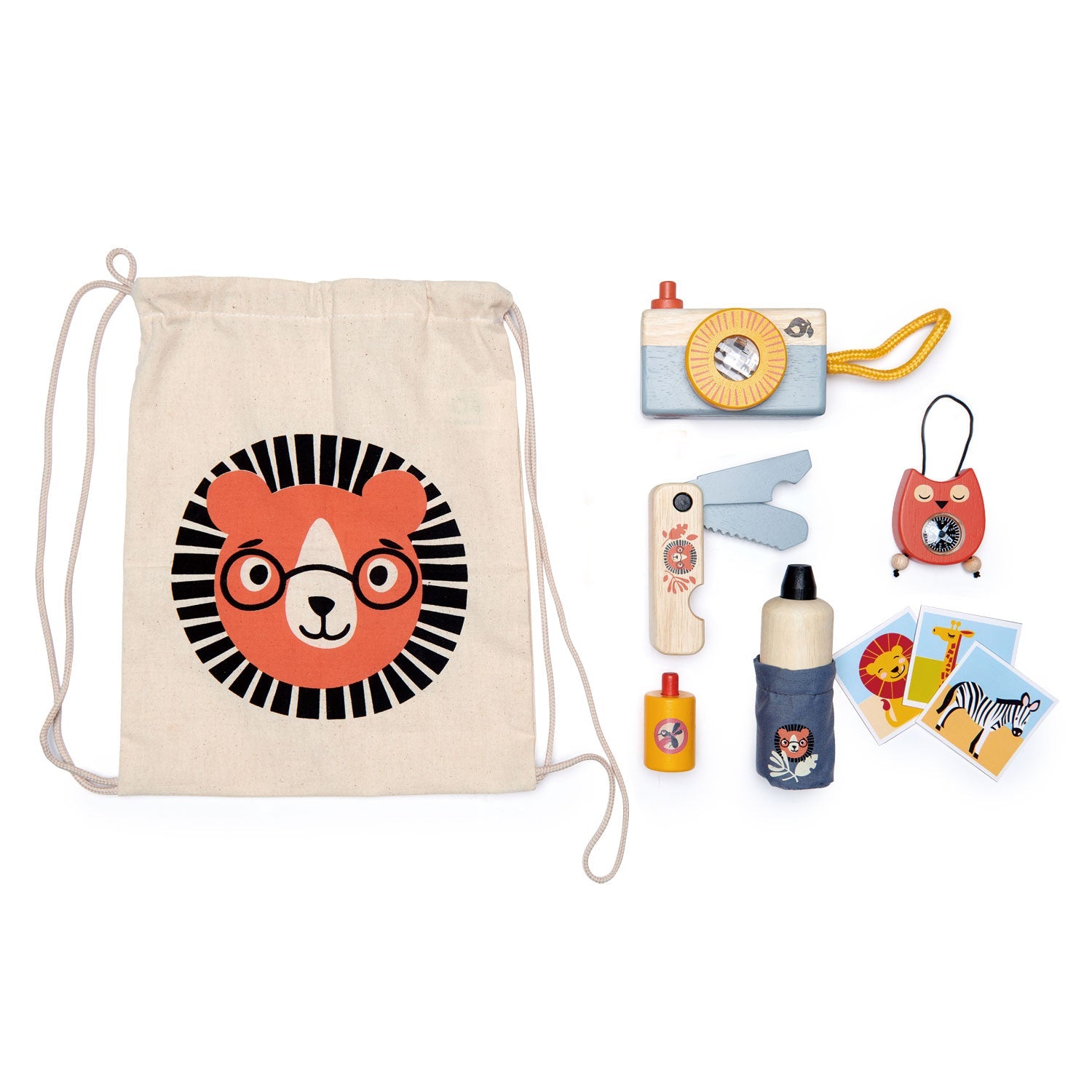 Safari spotter pack contents arranged flat — camera, compass, penknife, mosquito spray bottle, water bottle, zebra spotter cards