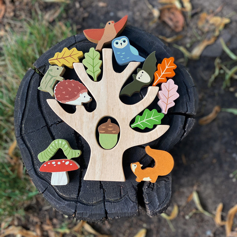 Close detail of the wooden owl and acorn pieces on the stacking forest